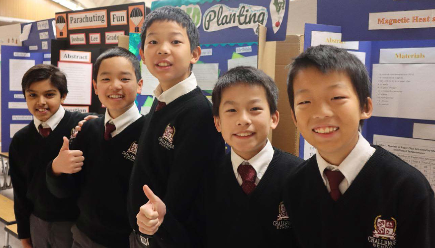 A group of middle school students with their Science Fair presentations