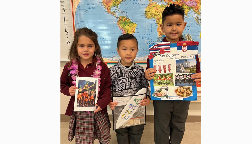 Three students dressed for Small World Days